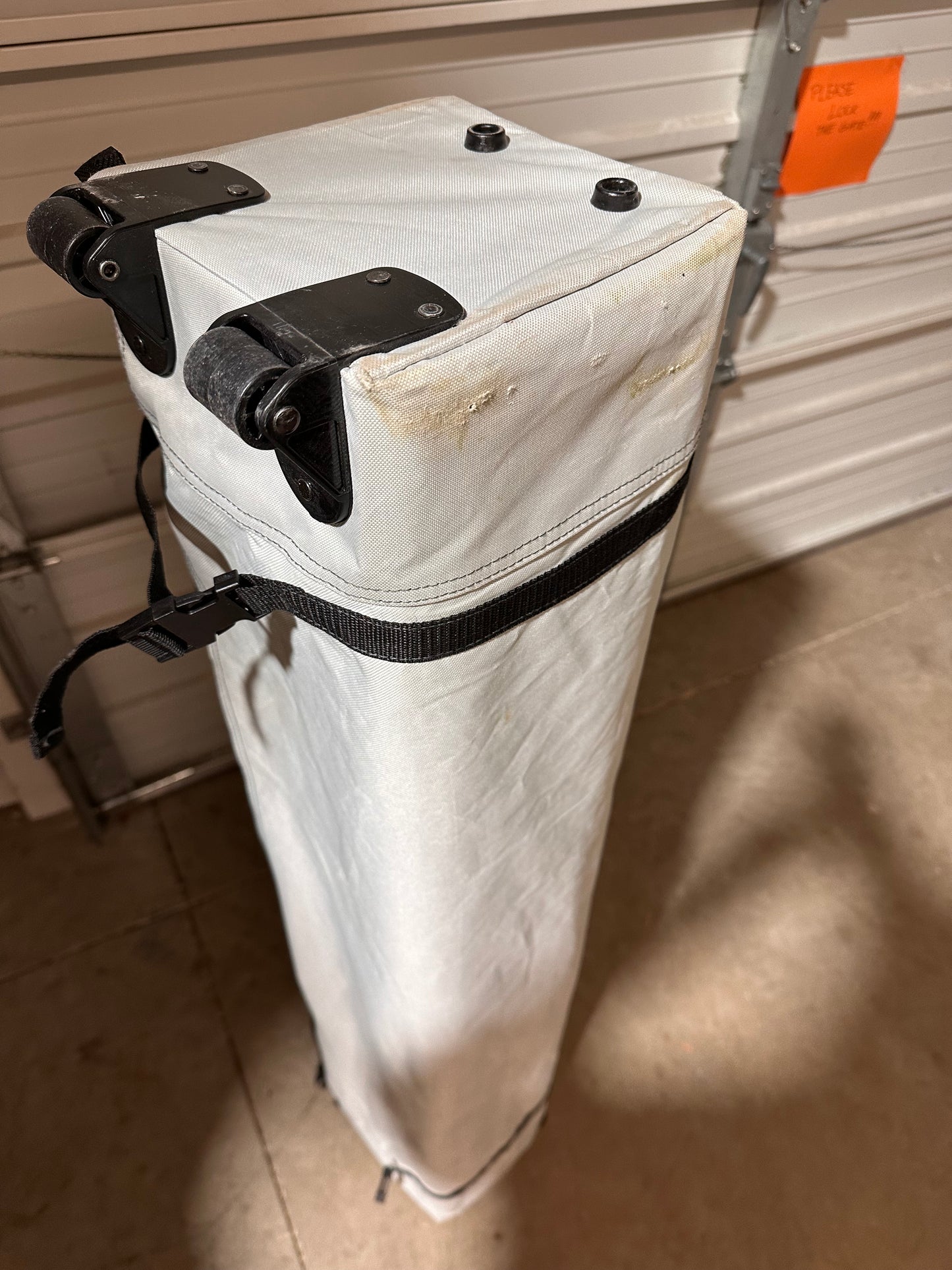 Used wheeled carry bag for 12' x 12' Ozark Trail canopy showing holes and wear