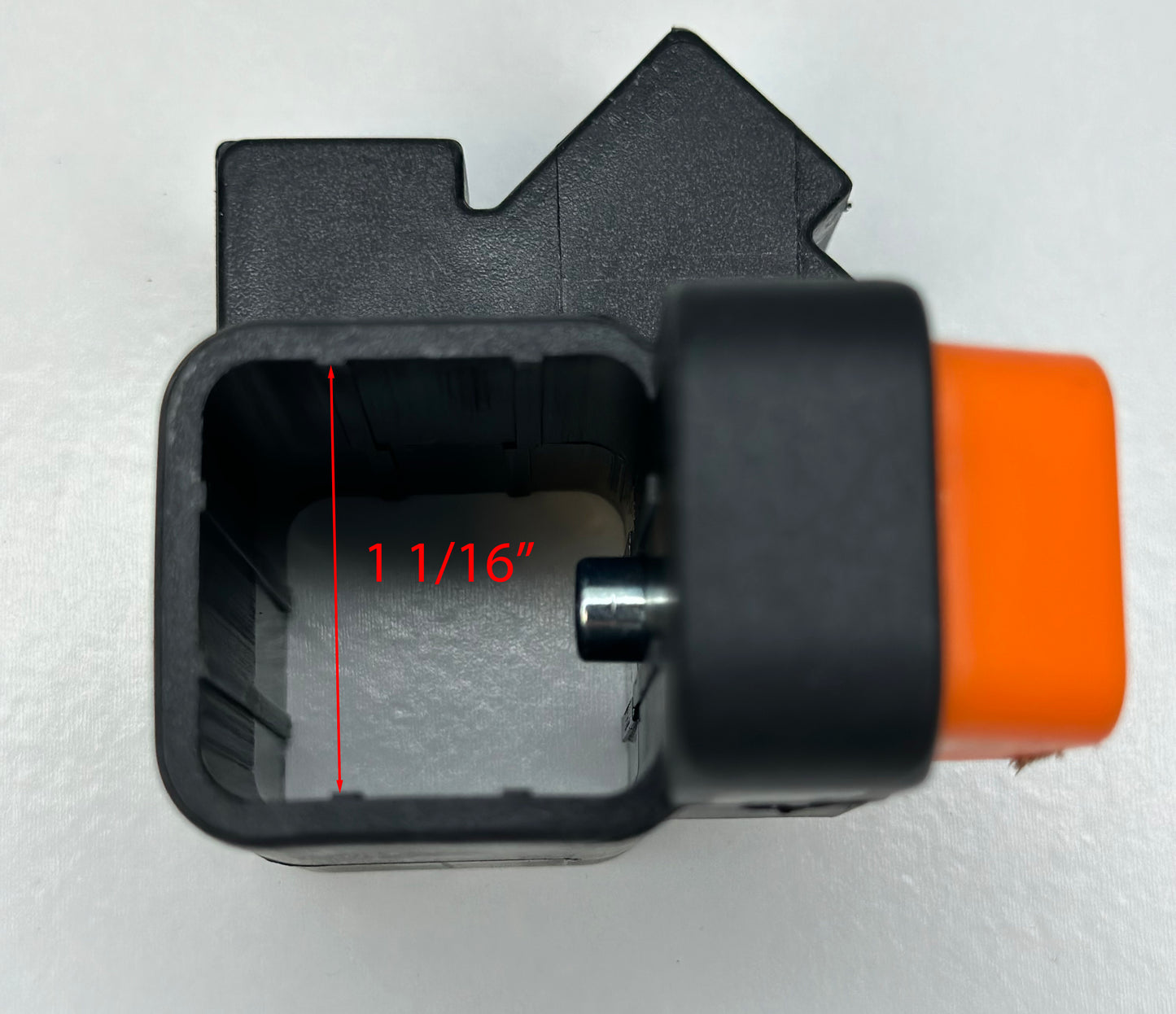 Top-down view of the interior of a black and orange leg slider, labeled with a measurement of 1 1/16 inches, for an Ozark Trail canopy's leg adjustment mechanism