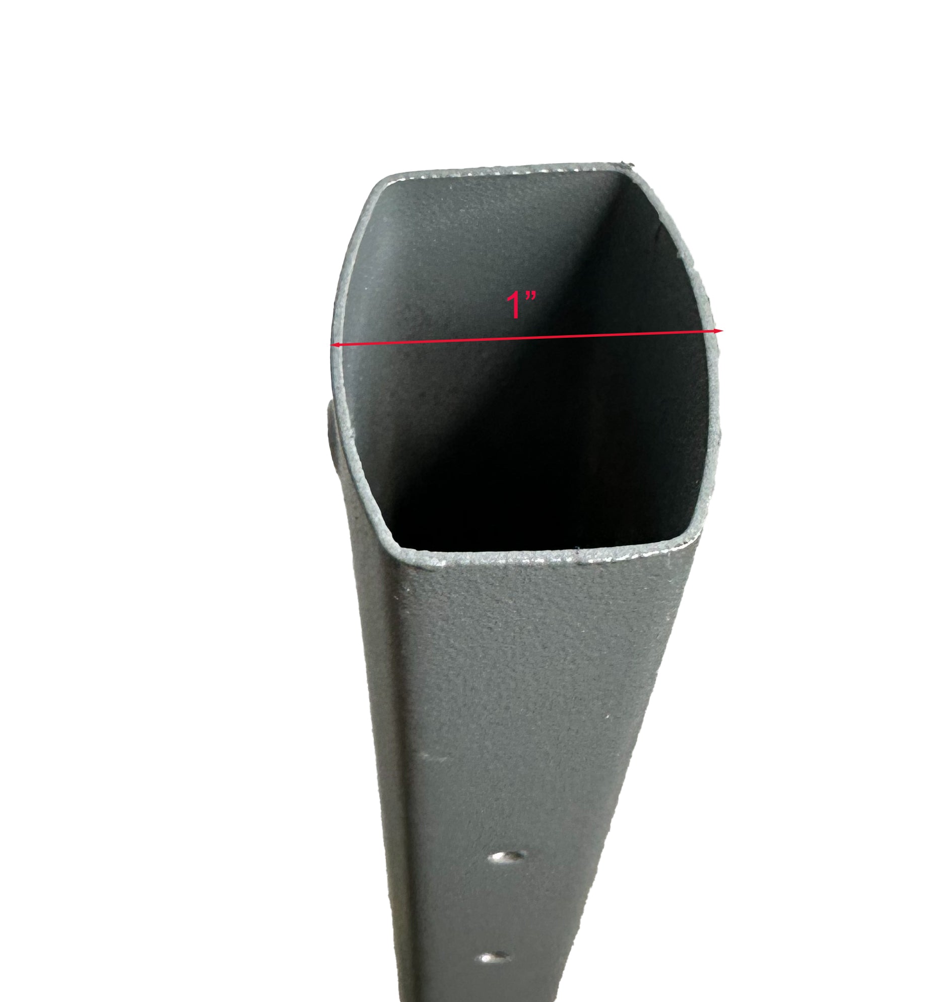 The image shows a close-up view of a dark gray, textured object with an oval opening. A red measurement line across the width of the opening indicates a dimension of 1 inch. The object appears to be made of a thick material, possibly metal or hard plastic, and has a series of small round holes drilled along one side. The background is plain and light-colored, providing a contrast that highlights the object's opening and the red measurement line.