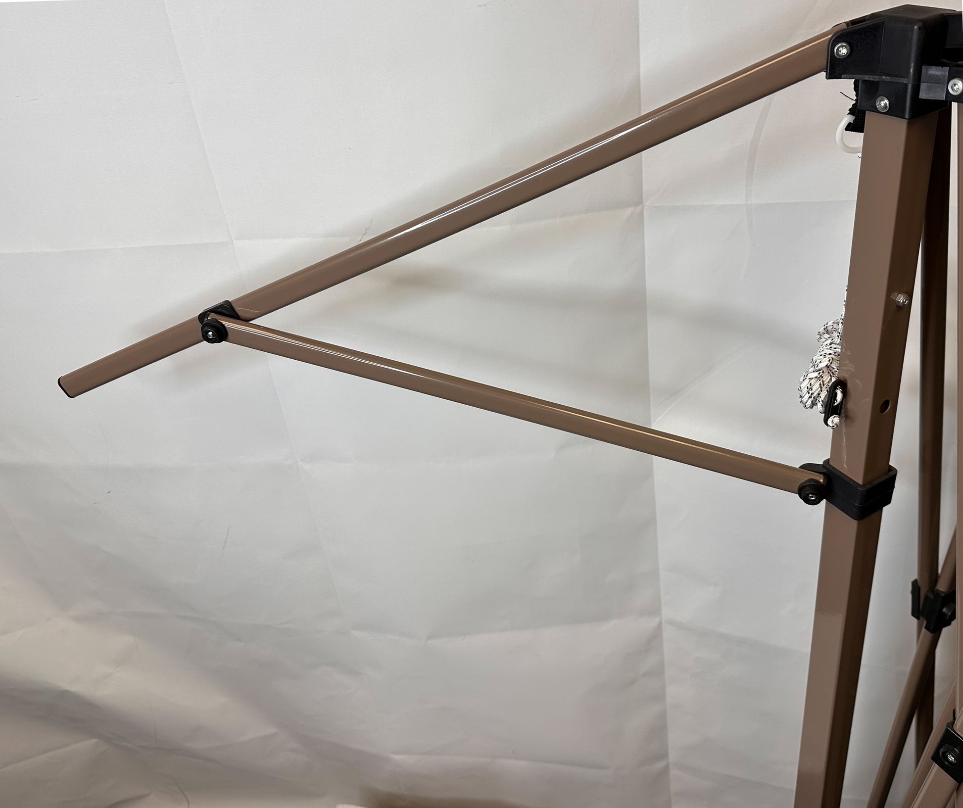 Extend lower roof pole truss bar installed on a 13×13 pop-up canopy frame, showing side roof position near the leg with hinged metal bars attached to the canopy structure against a white background.