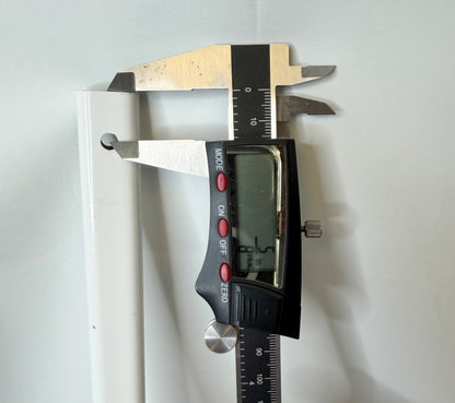 Digital caliper checking the distance between the mounting hole and the end of the canopy truss bar.